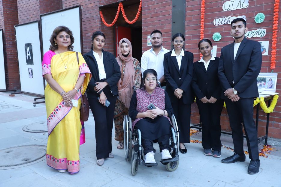 The Enable Education team together after an event, including a wheelchair user at the centre of the group.